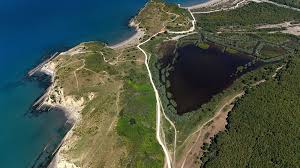 Jared Kushner Albania land dispute investigative scene showing Albanian coastline development, disputed land maps, and newsroom analysis of coastal investment tensions.